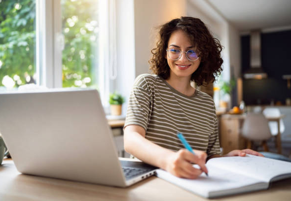 Young woman, a university student, studying online.